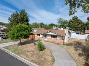 Bungalow-style home with brick siding and driveway