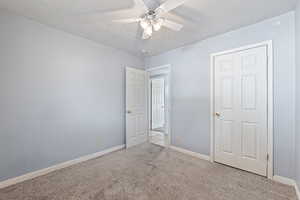 Unfurnished bedroom with carpet floors and ceiling fan