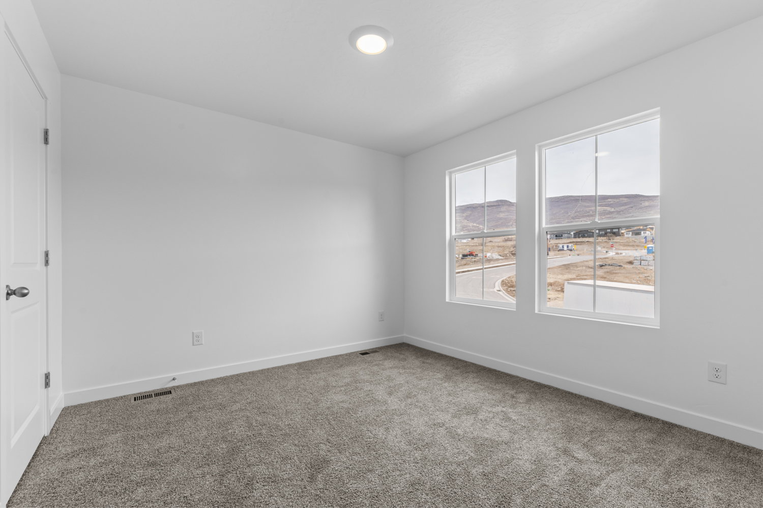 Carpeted spare room with baseboards