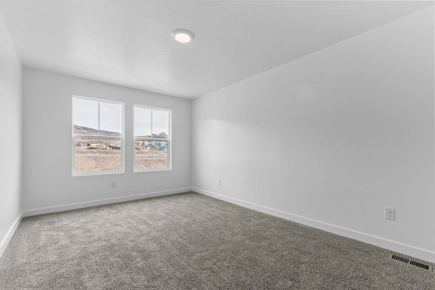 Carpeted empty room with baseboards