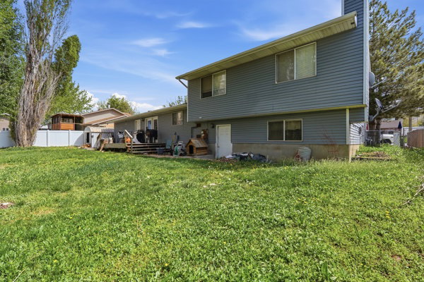 Rear view of property featuring a deck and a chimney