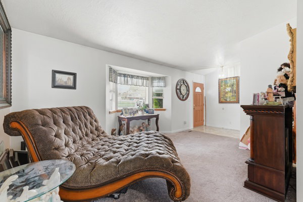 Bedroom featuring carpet floors and baseboards