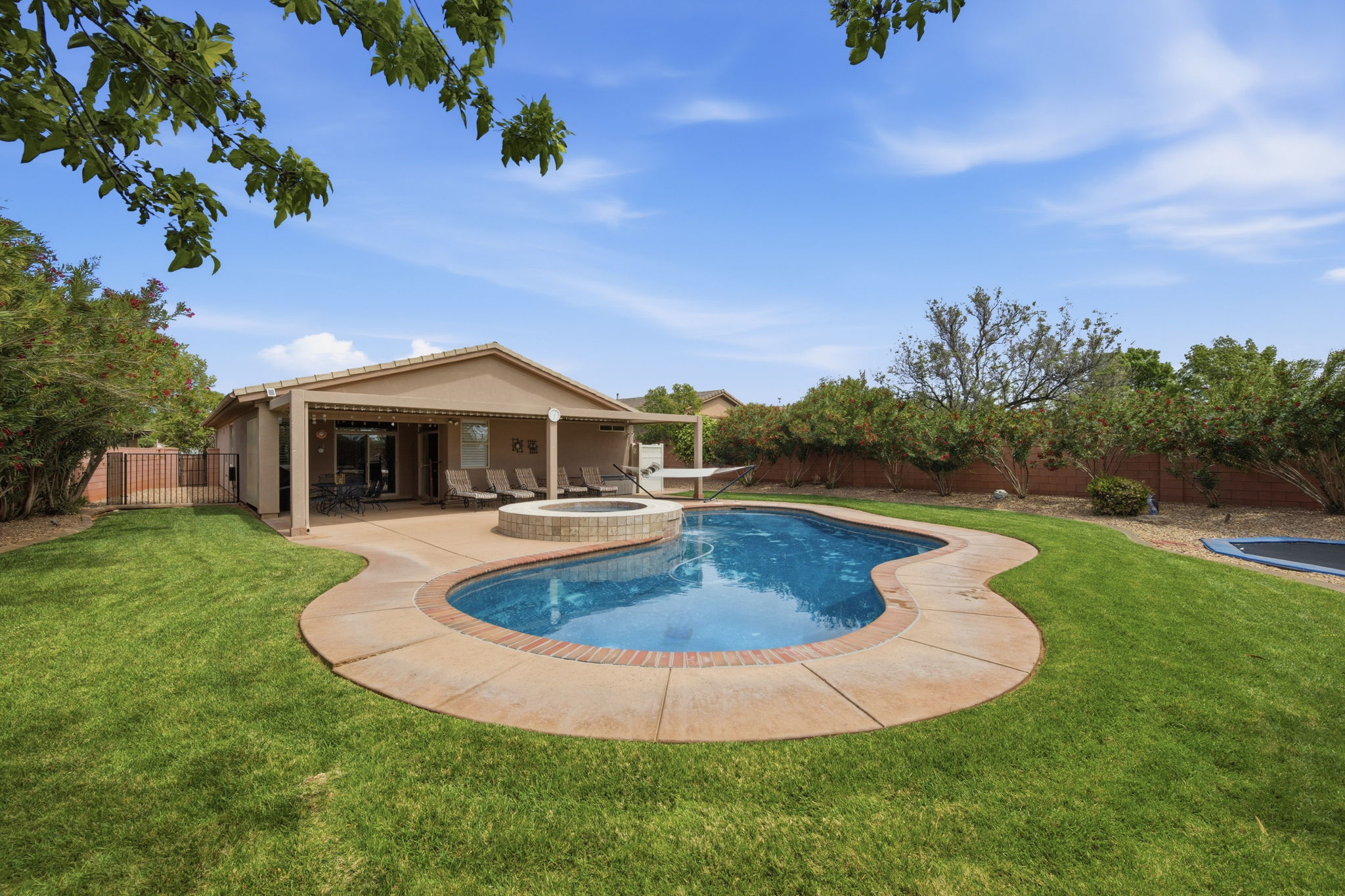 Relaxing pool / spa featuring a patio and a fenced backyard