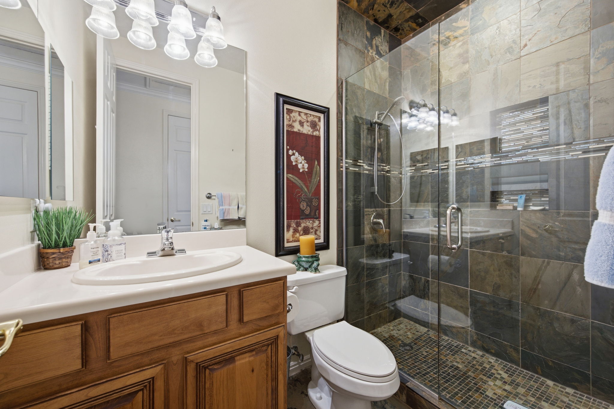 Full bath featuring vanity and a shower stall