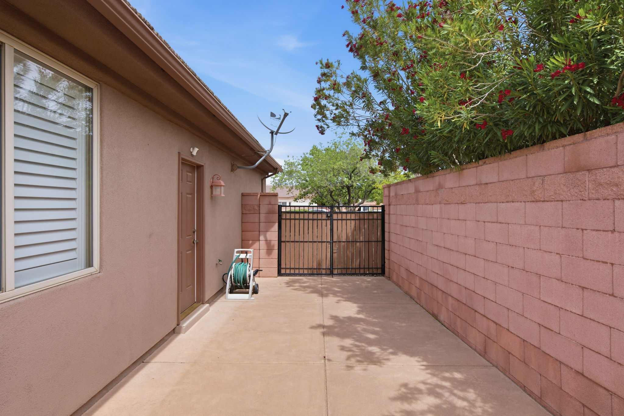 View of patio featuring a gate