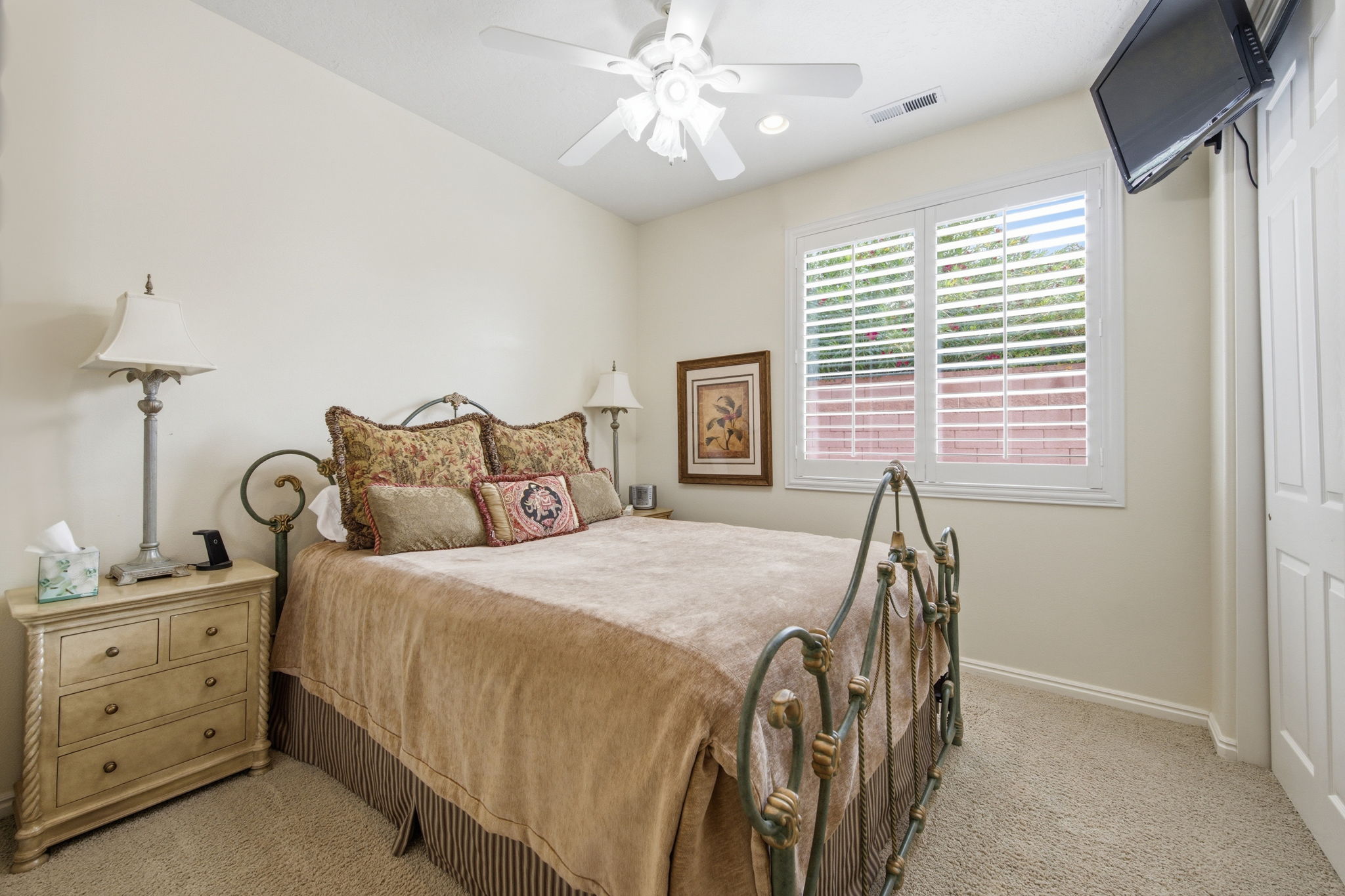 Bedroom featuring light colored carpet and a ceiling fan