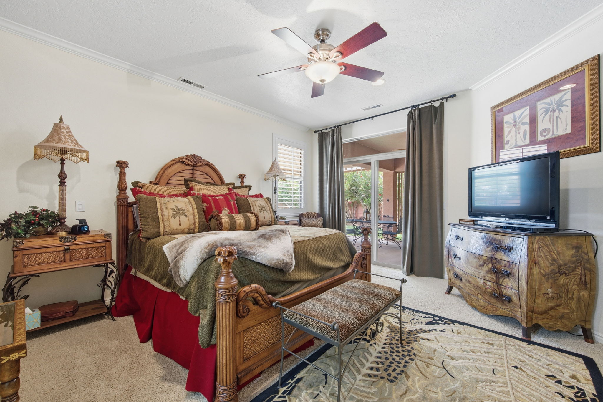 Bedroom with light colored carpet, crown molding, access to outside, a textured ceiling, and ceiling fan