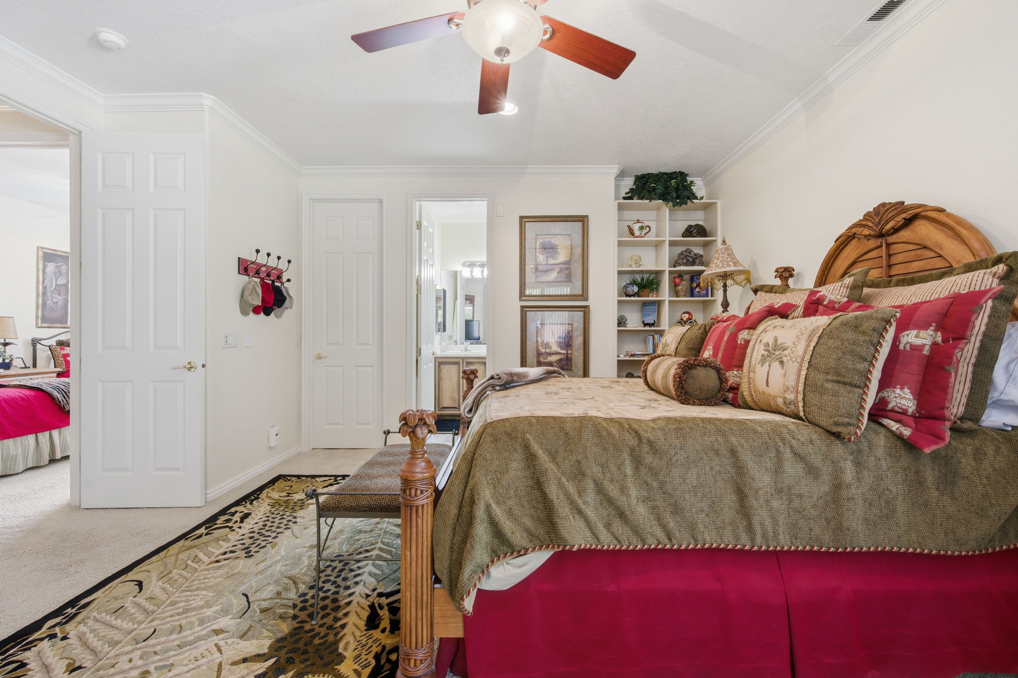 Bedroom with carpet flooring, crown molding, a ceiling fan, and connected bathroom