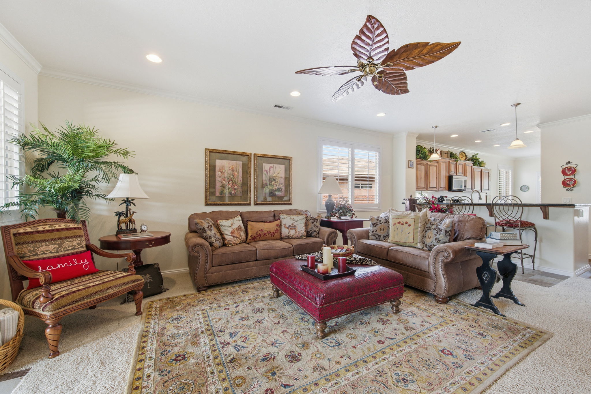 Living area featuring light colored carpet, ornamental molding, a ceiling fan, and recessed lighting