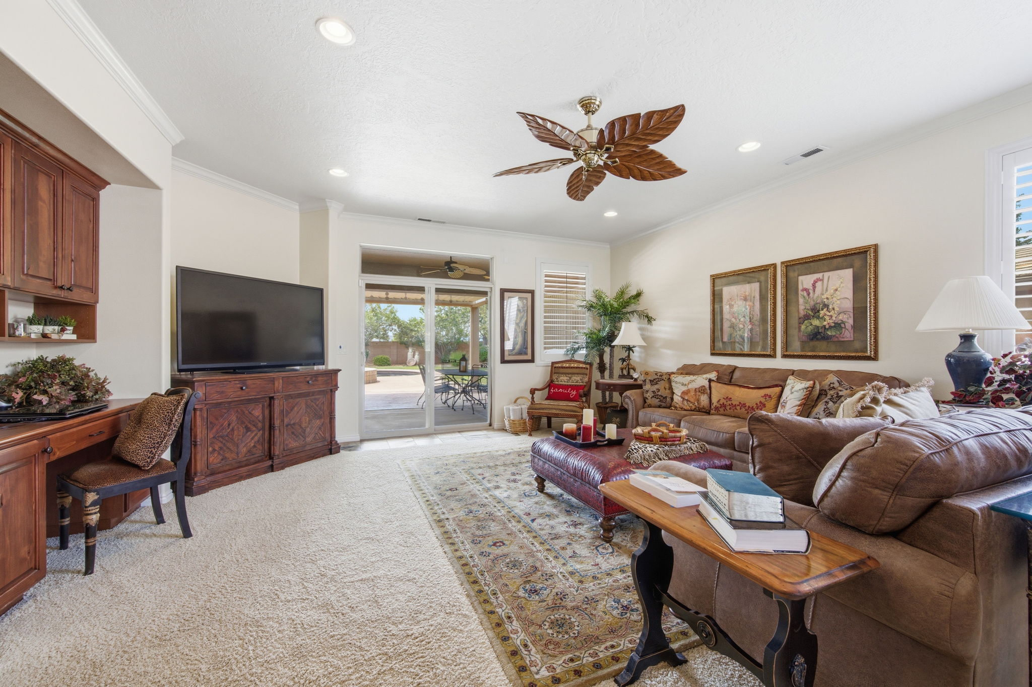 Living area featuring ceiling fan, ornamental molding, light colored carpet, and recessed lighting