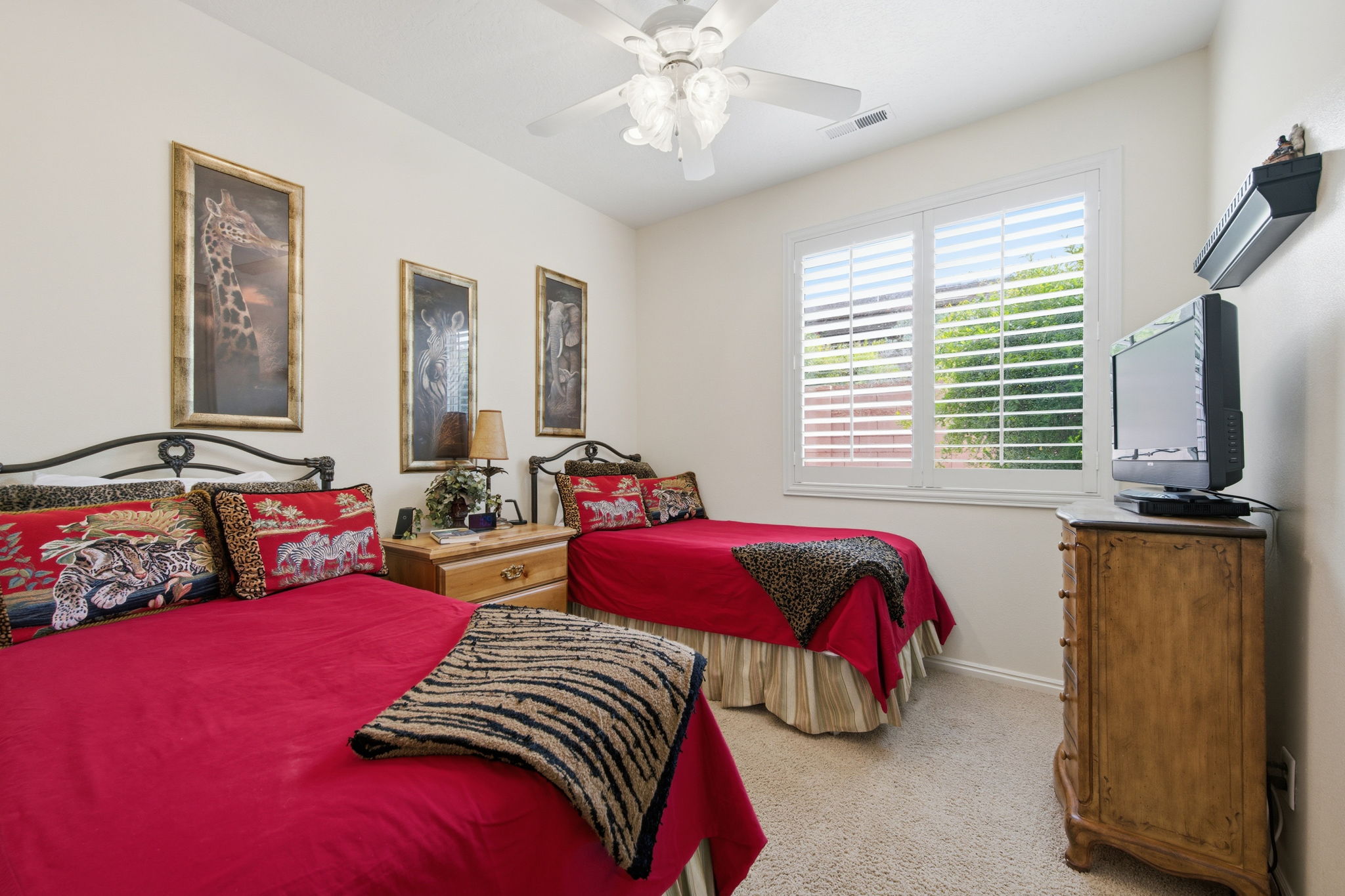 Bedroom featuring light colored carpet and ceiling fan
