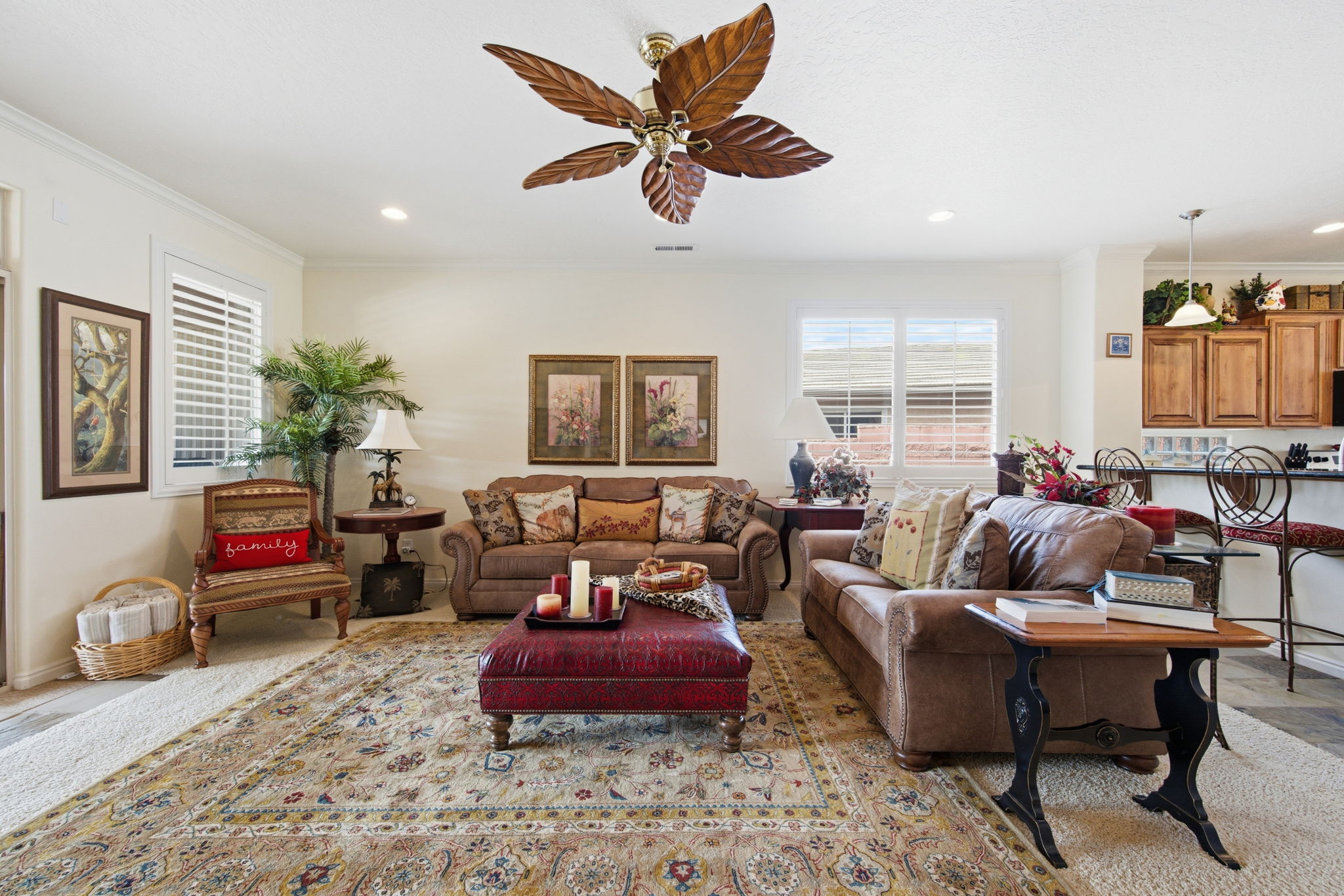 Living area with ceiling fan, ornamental molding, and recessed lighting
