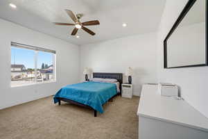 Bedroom featuring ceiling fan, light colored carpet, and recessed lighting