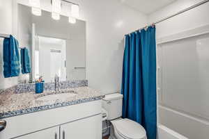 Full bathroom with vanity and shower / bath combo with shower curtain