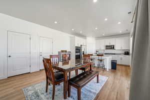 Dining room featuring light wood finished floors and recessed lighting