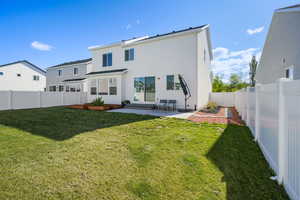 Back of property with a patio area, a fenced backyard, and stucco siding