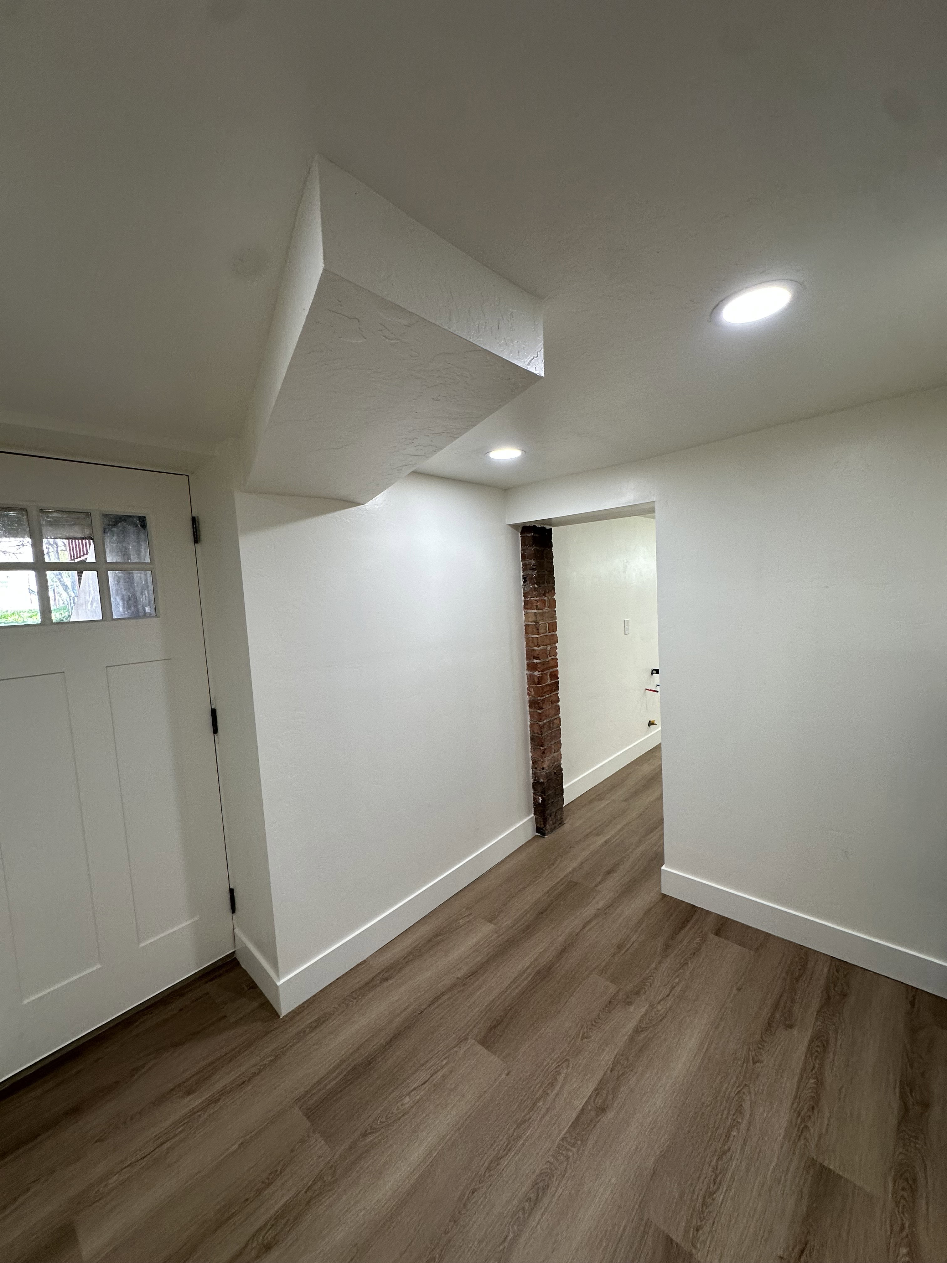 Basement with dark wood-style floors and recessed lighting