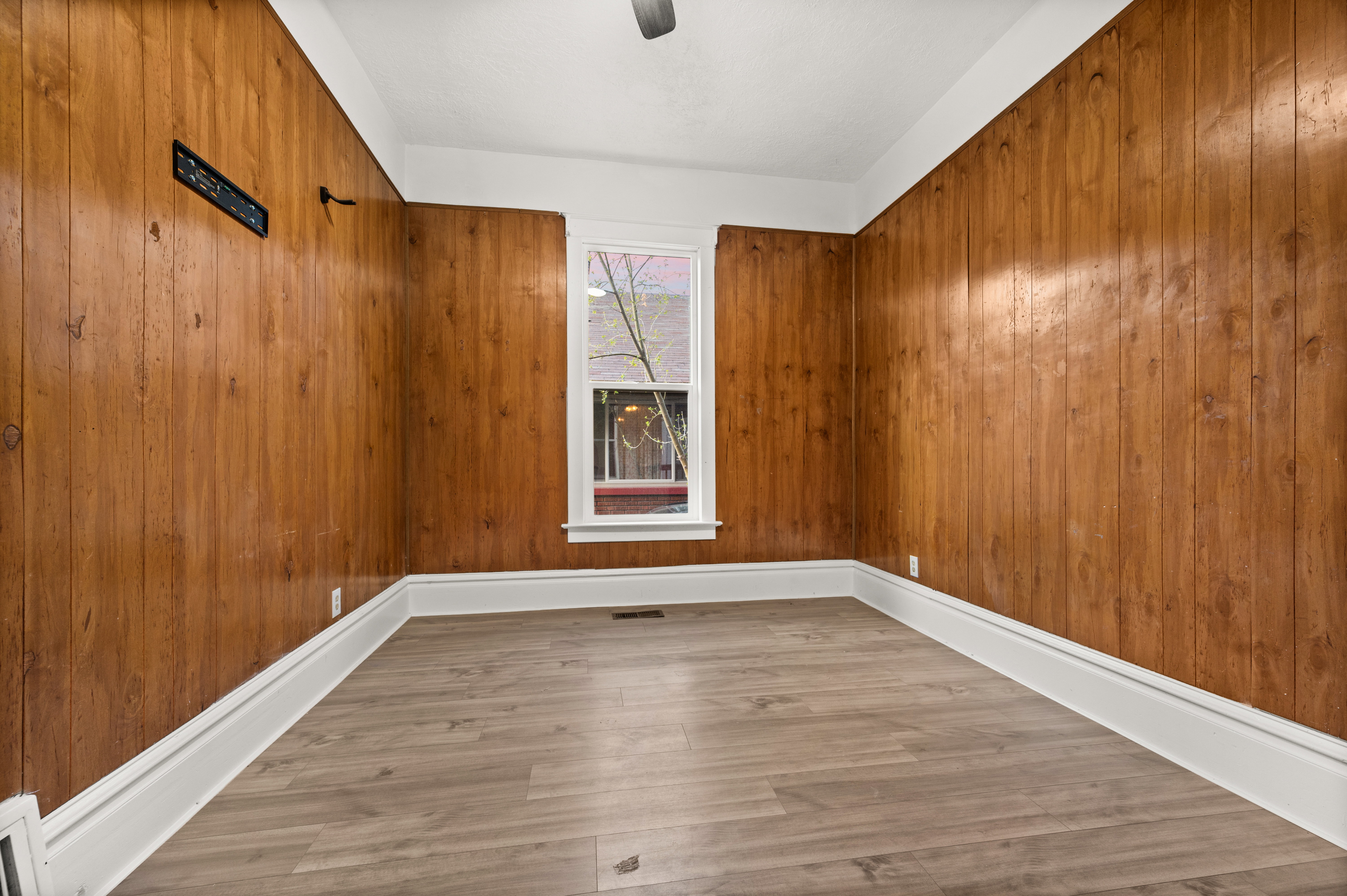 Spare room featuring light wood-style flooring and baseboards