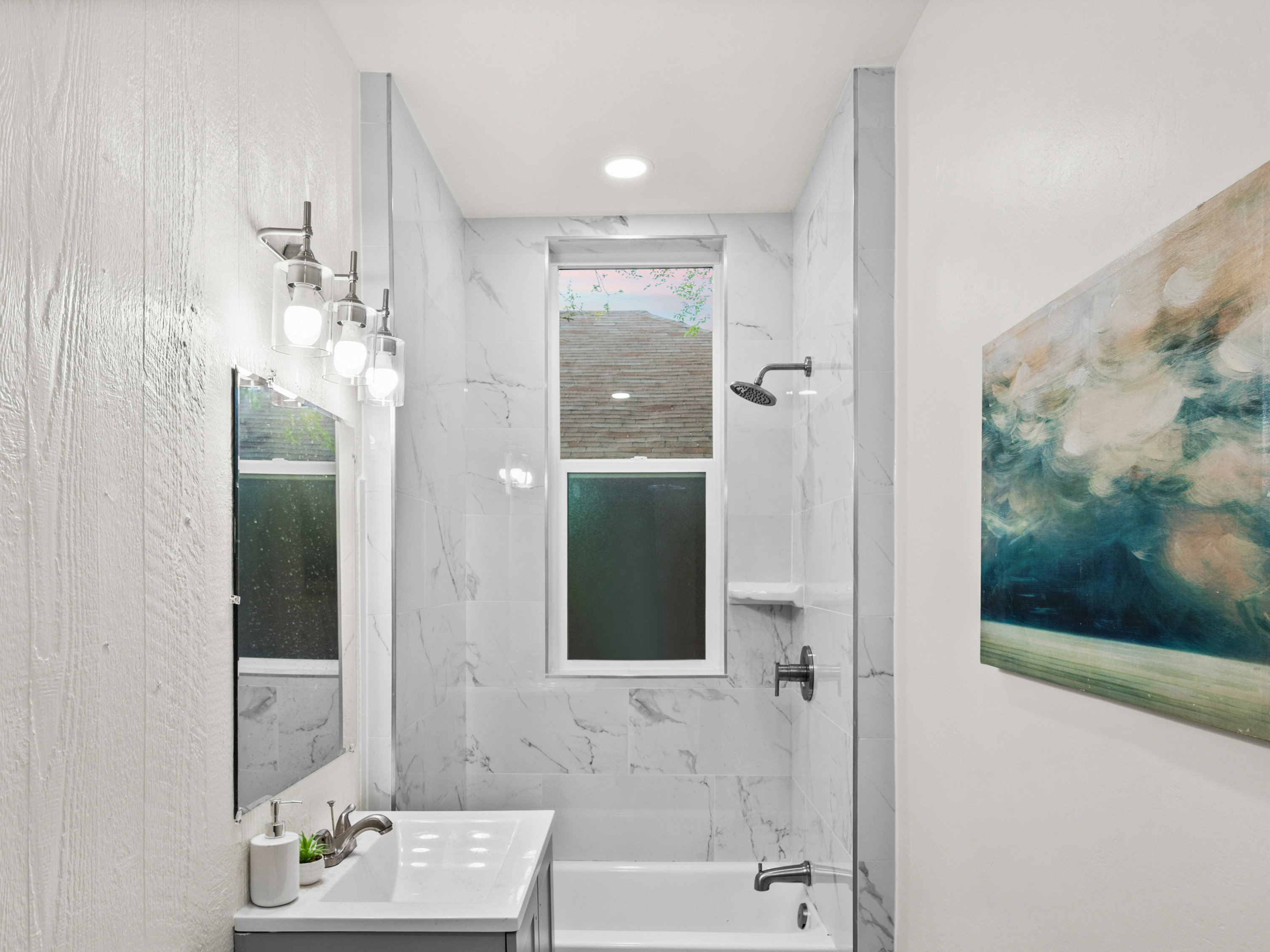 Bathroom with vanity, bathing tub / shower combination, and dark wood-style flooring