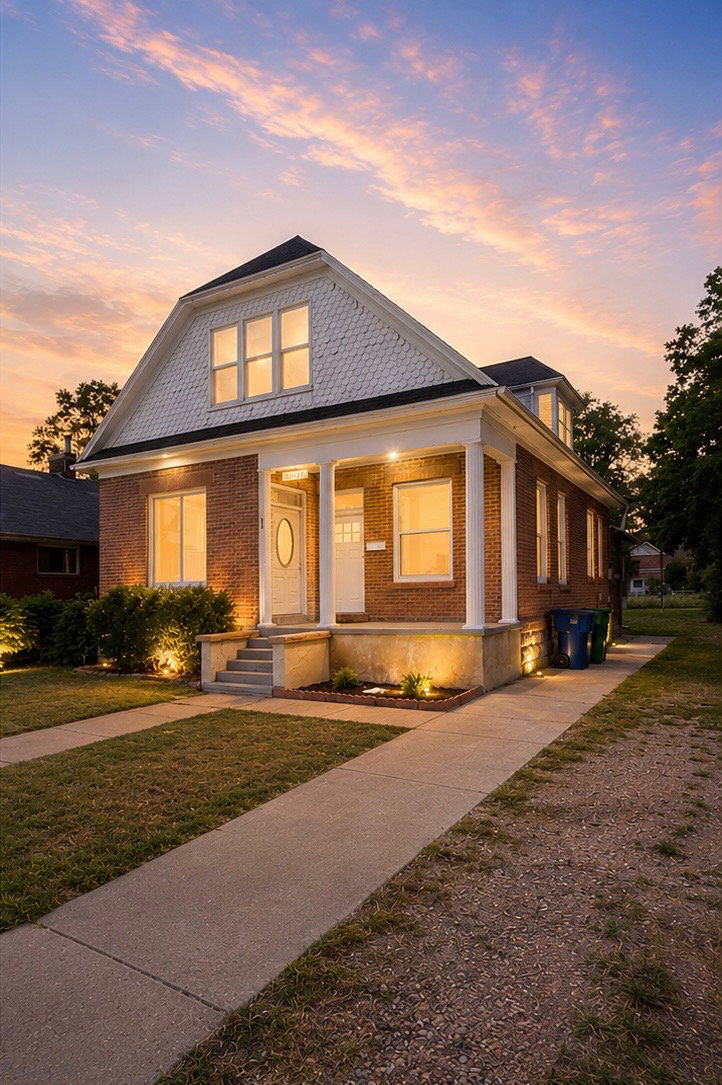 Brick and white shingle exterior featuring a columned front porch