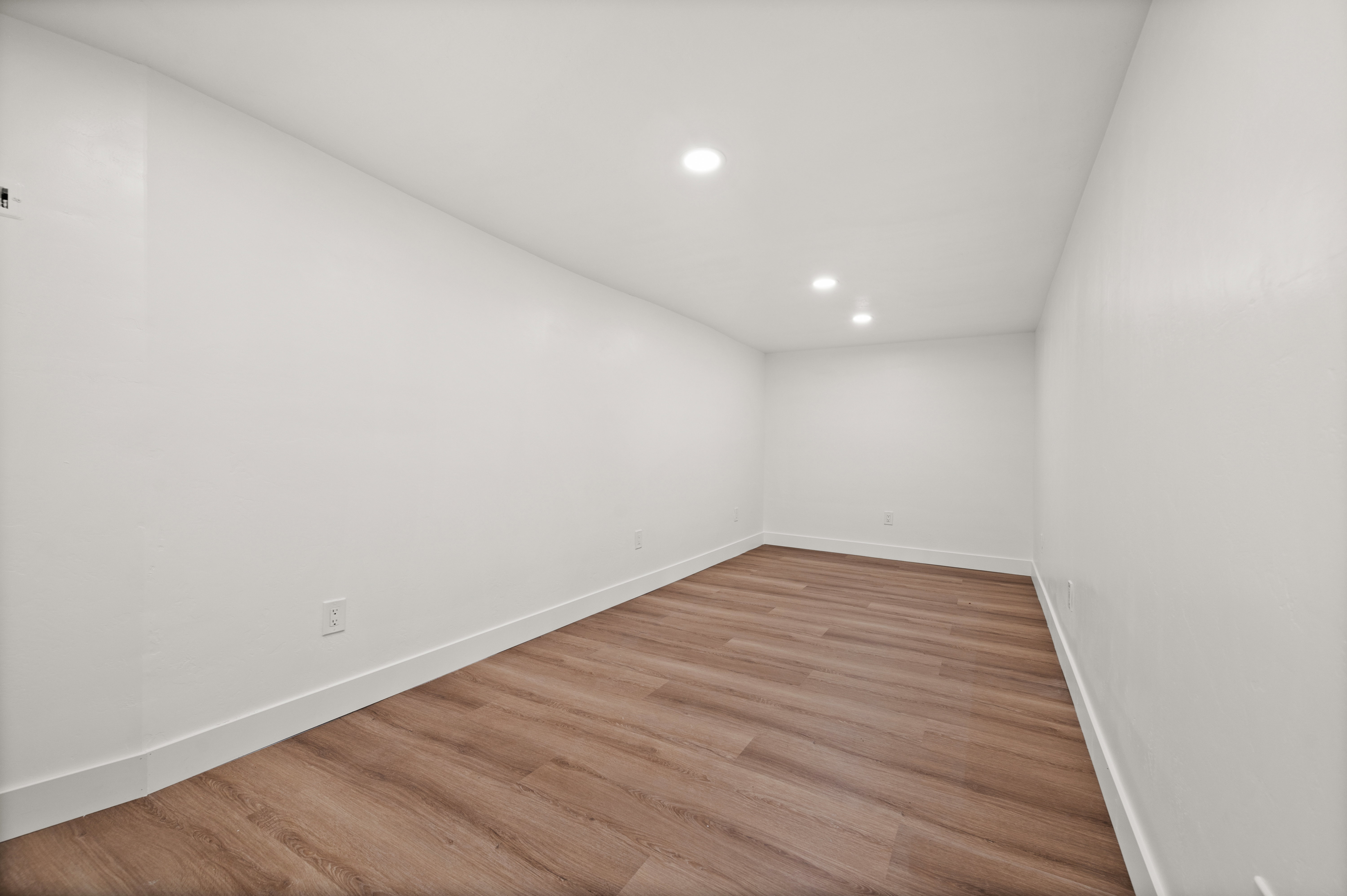 Unfurnished room featuring wood finished floors and recessed lighting