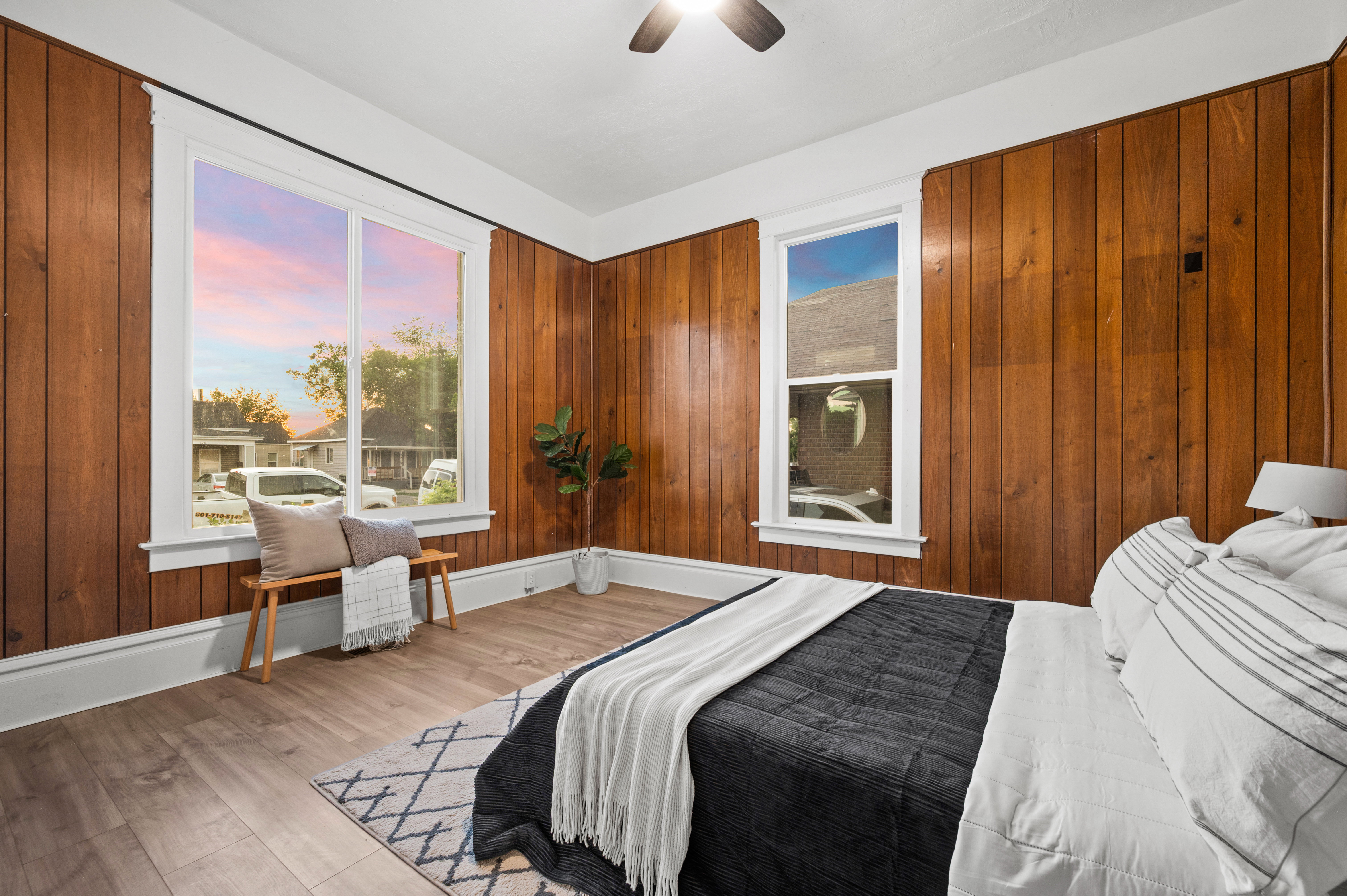 Bedroom featuring wood paneling on three walls