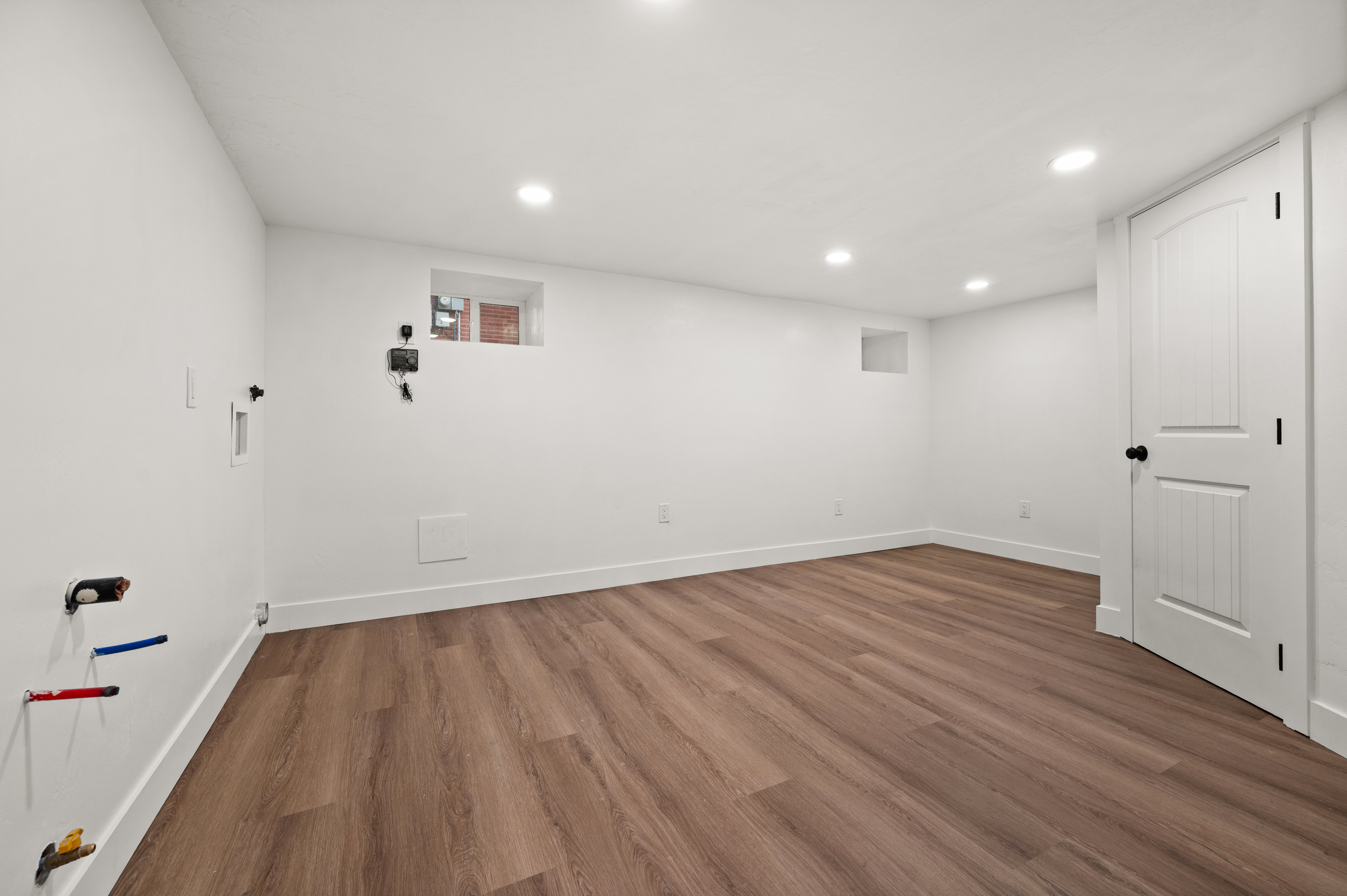 Interior space with dark wood-style flooring and recessed lighting