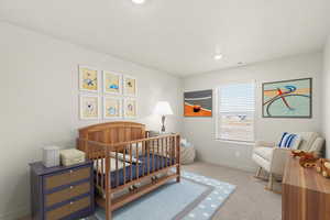Bedroom with a nursery area, light carpet, and recessed lighting
