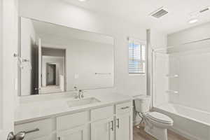 Full bathroom featuring vanity, shower / washtub combination, and light wood finished floors