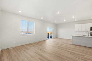 Unfurnished living room with light wood-style flooring and recessed lighting