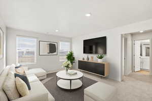 Living area featuring light colored carpet, recessed lighting, and a textured ceiling