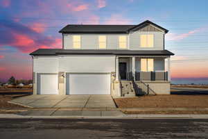 View of front of house featuring a porch, concrete driveway, board and batten siding, a shingled roof, and an attached garage