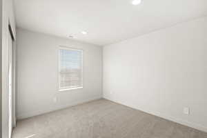Unfurnished room with light carpet and recessed lighting