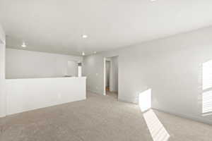 Spare room with light colored carpet and recessed lighting