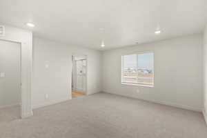 Unfurnished room featuring light carpet and recessed lighting