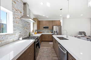 Kitchen with stainless steel appliances, dark wood-type flooring, backsplash, light stone countertops, and modern cabinets