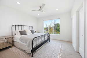 Bedroom with light colored carpet, a ceiling fan, and recessed lighting