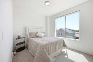 Bedroom with light carpet