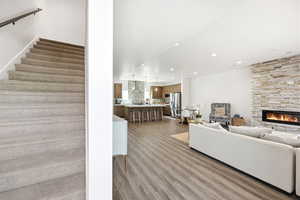Living room with light wood finished floors, a fireplace, and recessed lighting