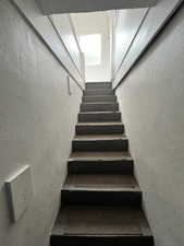 Stairway featuring a textured wall
