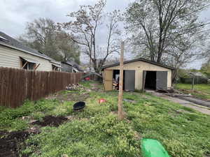 Fenced yard with an outdoor structure
