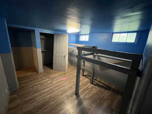 Bedroom featuring wood finished floors and a closet