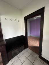 Mudroom with light tile patterned floors and baseboards