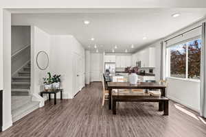 Dining room with dark wood-style floors and recessed lighting