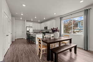 Dining area featuring dark wood finished floors and recessed lighting