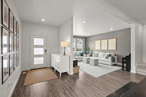 Living room with dark wood-style floors and recessed lighting