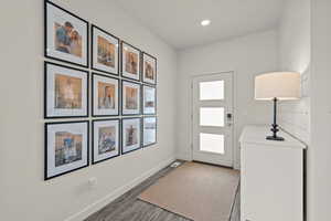 Doorway to outside featuring wood finished floors and recessed lighting