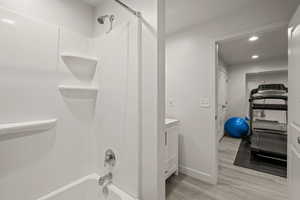 Full bathroom featuring vanity, recessed lighting, light wood finished floors, and bathing tub / shower combination