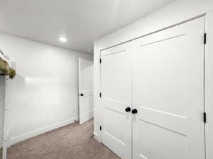 Unfurnished bedroom featuring carpet, a closet, and recessed lighting