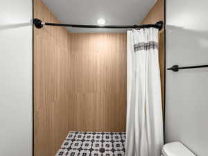 Bathroom featuring a textured ceiling and a shower stall